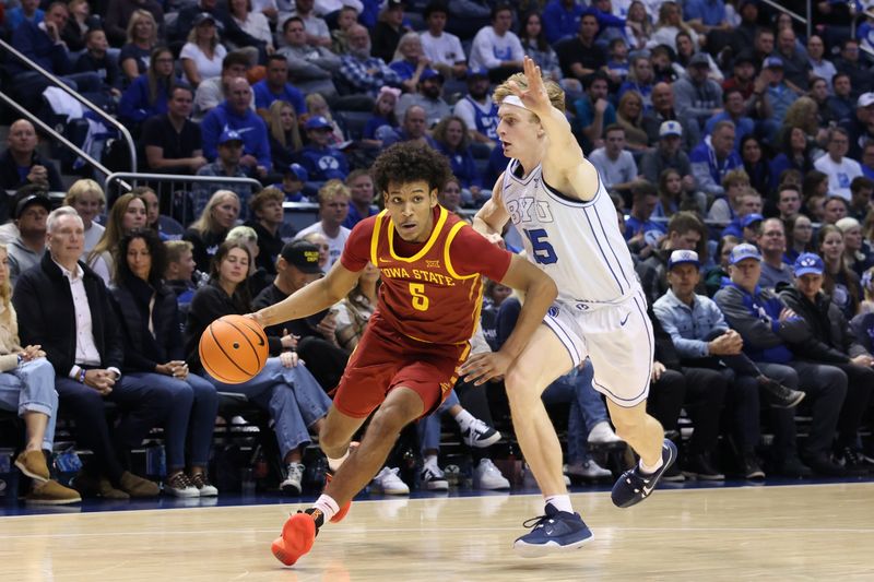 Jan 16, 2024; Provo, Utah, USA; Iowa State Cyclones guard Curtis Jones (5) drives against Brigham Young Cougars guard Richie Saunders (15) during the second half at Marriott Center. Mandatory Credit: Rob Gray-USA TODAY Sports