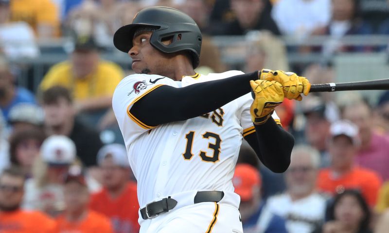 Jun 4, 2025; Pittsburgh, Pennsylvania, USA;  Pittsburgh Pirates third baseman Ke'Bryan Hayes (13) hits a single against the Houston Astros during the third inning at PNC Park. Mandatory Credit: Charles LeClaire-Imagn Images