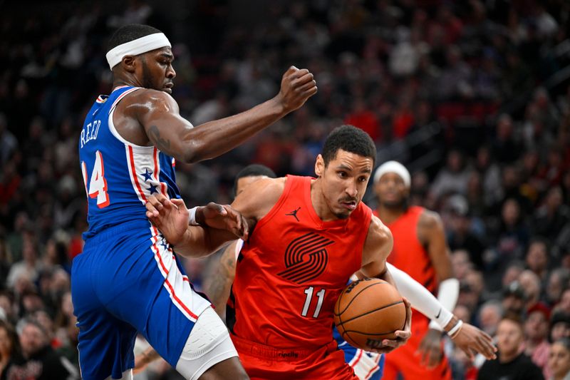 PORTLAND, OREGON - JANUARY 29: Malcolm Brogdon #11 of the Portland Trail Blazers drives against Paul Reed #44 of the Philadelphia 76ers during the first quarter at the Moda Center on January 29, 2024 in Portland, Oregon. NOTE TO USER: User expressly acknowledges and agrees that, by downloading and or using this photograph, User is consenting to the terms and conditions of the Getty Images License Agreement. (Photo by Alika Jenner/Getty Images)