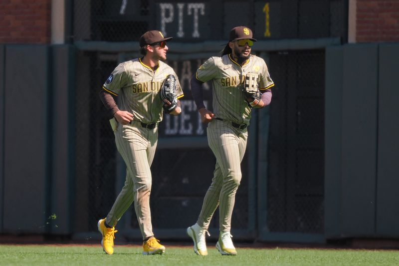 Apr 5, 2024; San Francisco, California, USA; San Diego Padres center fielder Jackson Merrill (3) and right fielder Fernando Tatis Jr. (23) jog back to the dugout after the sixth inning against the San Francisco Giants at Oracle Park. Mandatory Credit: Kelley L Cox-USA TODAY Sports