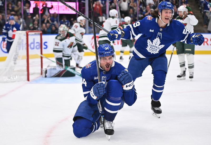 Oct 14, 2023; Toronto, Ontario, CAN;   Toronto Maple Leafs forward Auston Matthews (34) celebrates with forward Tyler Bertuzzi (59) after scoring his third goal of the game against the Minnesota Wild in the third period at Scotiabank Arena. Mandatory Credit: Dan Hamilton-USA TODAY Sports