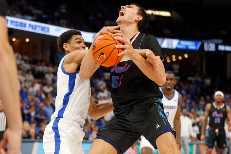 Feb 25, 2024; Memphis, Tennessee, USA; Florida Atlantic Owls center Vladislav Goldin (50) drives to the basket as Memphis Tigers forward Nicholas Jourdain (2) defends during the second half at FedExForum. Mandatory Credit: Petre Thomas-USA TODAY Sports