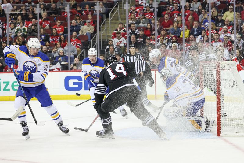 Oct 27, 2023; Newark, New Jersey, USA; Buffalo Sabres center Casey Mittelstadt (37) and New Jersey Devils right wing Nathan Bastian (14) battles for the puck in front of goaltender Eric Comrie (31) during the first period at Prudential Center. Mandatory Credit: Vincent Carchietta-USA TODAY Sports