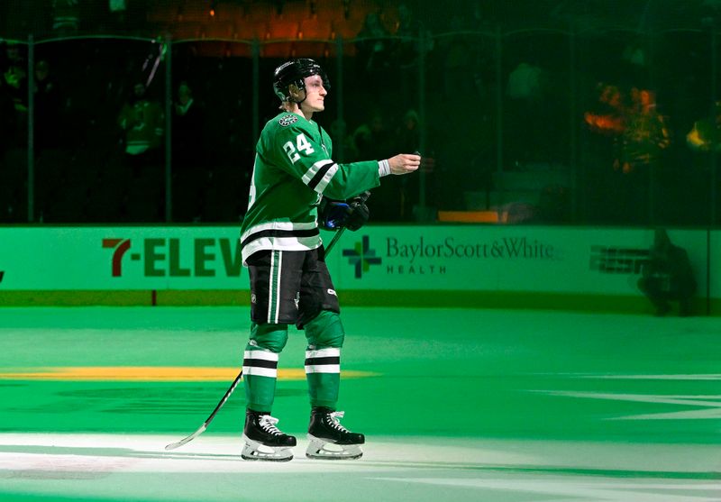Jan 16, 2024; Dallas, Texas, USA; Dallas Stars center Roope Hintz (24) throws a puck to the fans after he is named the number three star in the Stars victory over the Los Angeles Kings at the American Airlines Center. Mandatory Credit: Jerome Miron-USA TODAY Sports