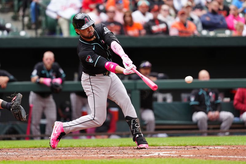 May 12, 2024; Baltimore, Maryland, USA; Arizona Diamondbacks third baseman Eugenio Suarez (28) hits a double against the Baltimore Orioles during the fifth inning at Oriole Park at Camden Yards. Mandatory Credit: Gregory Fisher-USA TODAY Sports