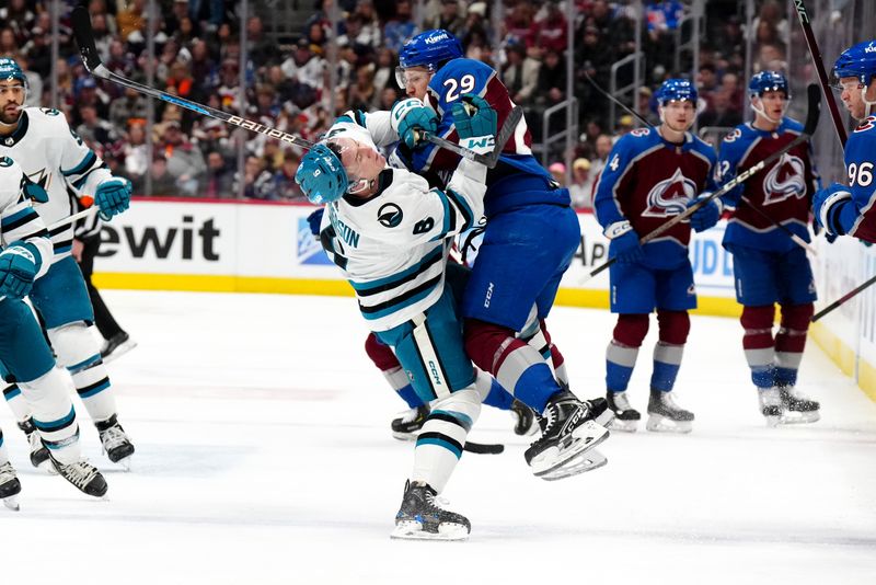 Dec 31, 2023; Denver, Colorado, USA; Colorado Avalanche center Nathan MacKinnon (29) hits San Jose Sharks defenseman Ty Emberson (6) in the second period at Ball Arena. Mandatory Credit: Ron Chenoy-USA TODAY Sports