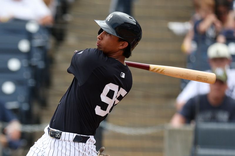 Mar 18, 2024; Tampa, Florida, USA;  New York Yankees first baseman Oswaldo Cabrera (95) hits a solo home run against the Philadelphia Phillies in the third inning at George M. Steinbrenner Field. Mandatory Credit: Nathan Ray Seebeck-USA TODAY Sports