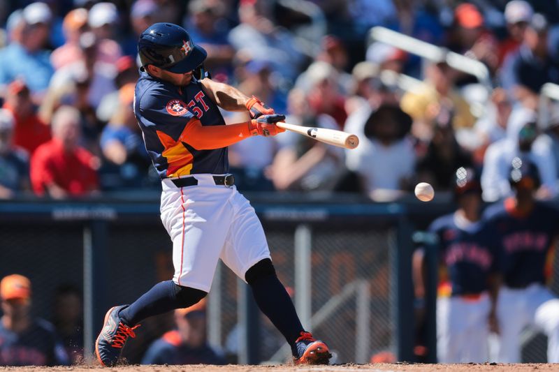 Mar 11, 2025; West Palm Beach, Florida, USA; Houston Astros left fielder Jose Altuve (27) hots a two-run double against the New York Mets during the seventh inning at CACTI Park of the Palm Beaches. Mandatory Credit: Sam Navarro-Imagn Images