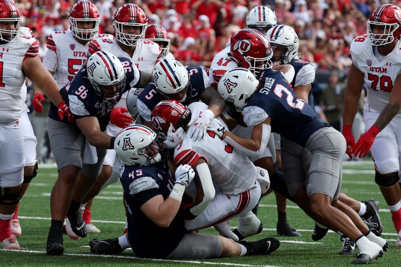 Nov 18, 2023; Tucson, Arizona, USA; Utah Utes running back Ja'Quinden Jackson (3) is tackled by Arizona Wildcats defensive lineman Bill Norton (45) and linebacker Jacob Manu (5) during the first half at Arizona Stadium. Mandatory Credit: Zachary BonDurant-USA TODAY Sports