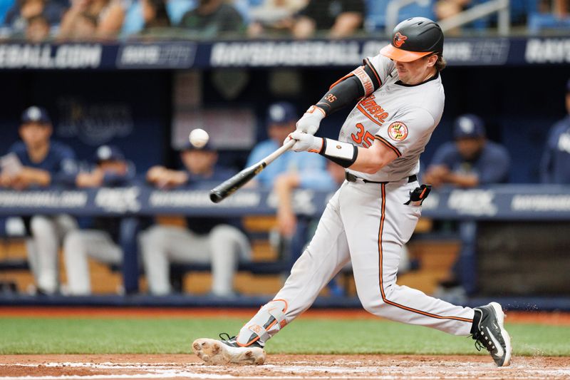 Jun 9, 2024; St. Petersburg, Florida, USA;  Baltimore Orioles catcher Adley Rutschman (35) hits an rbi single against the Tampa Bay Rays in the third inning at Tropicana Field. Mandatory Credit: Nathan Ray Seebeck-USA TODAY Sports