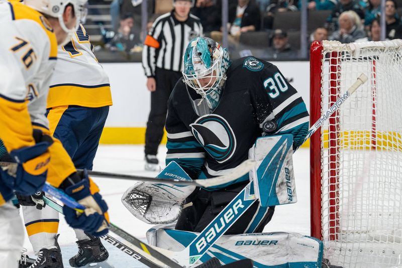 Jan 23, 2025; San Jose, California, USA;  San Jose Sharks goaltender Yaroslav Askarov (30) makes a save against the Nashville Predators during the third period at SAP Center at San Jose. Mandatory Credit: Neville E. Guard-Imagn Images