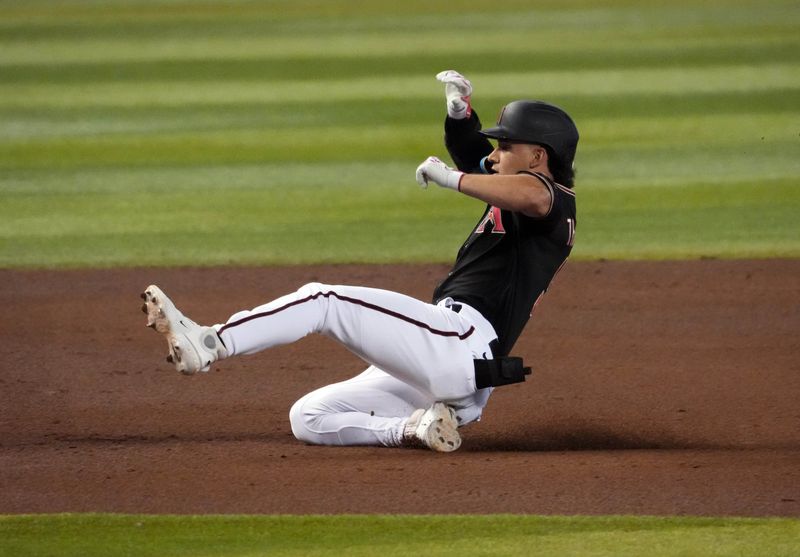 Jul 29, 2023; Phoenix, Arizona, USA; Arizona Diamondbacks center fielder Alek Thomas (5) slides into third base with a triple against the Seattle Mariners during the fifth inning at Chase Field. Mandatory Credit: Joe Camporeale-USA TODAY Sports