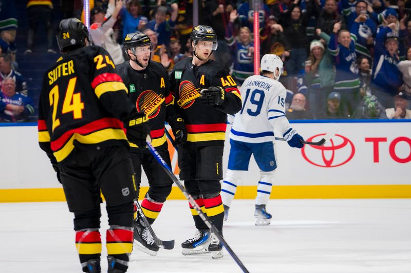 Jan 20, 2024; Vancouver, British Columbia, CAN; Vancouver Canucks forward Pius Suter (24), forward J.T. Miller (9) and forward Elias Pettersson (40) celebrate Miller   s goal against the Toronto Maple Leafs in the third period at Rogers Arena. Canucks won 6-4. Mandatory Credit: Bob Frid-USA TODAY Sports