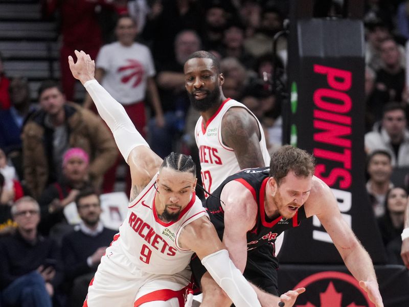 TORONTO, ON - FEBRUARY 9: Dillon Brooks #9 of the Houston Rockets and Jakob Poeltl #19 of the Toronto Raptors dive for a ball during the second half of their basketball game at the Scotiabank Arena on February 9, 2024 in Toronto, Ontario, Canada. NOTE TO USER: User expressly acknowledges and agrees that, by downloading and/or using this Photograph, user is consenting to the terms and conditions of the Getty Images License Agreement. (Photo by Mark Blinch/Getty Images)