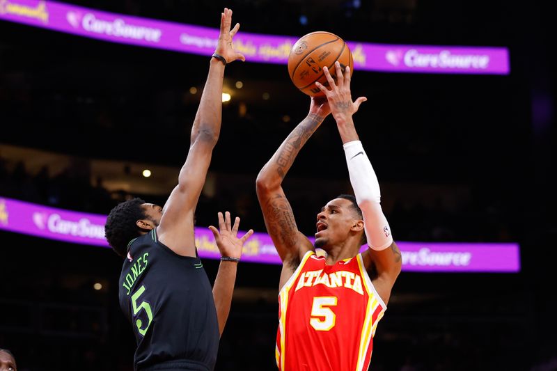 ATLANTA, GEORGIA - MARCH 10: Dejounte Murray #5 of the Atlanta Hawks shoots against Herbert Jones #5 of the New Orleans Pelicans during the second quarter at State Farm Arena on March 10, 2024 in Atlanta, Georgia. NOTE TO USER: User expressly acknowledges and agrees that, by downloading and or using this photograph, User is consenting to the terms and conditions of the Getty Images License Agreement. (Photo by Todd Kirkland/Getty Images)