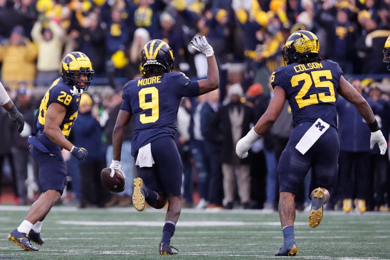 Nov 25, 2023; Ann Arbor, Michigan, USA; Michigan Wolverines defensive back Rod Moore (9) celebrates after he makes an interception in the second half against the Ohio State Buckeyes at Michigan Stadium. Mandatory Credit: Rick Osentoski-USA TODAY Sports