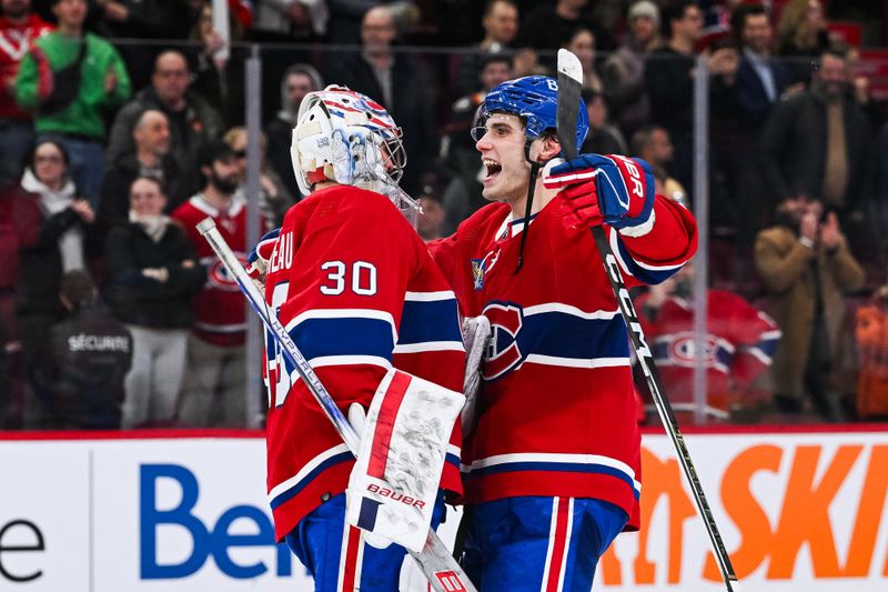 Feb 13, 2024; Montreal, Quebec, CAN; Montreal Canadiens left wing Juraj Slafkovsky (20) celebrates the shootout win against the Anaheim Ducks with goalie Cayden Primeau (30) at Bell Centre. Mandatory Credit: David Kirouac-USA TODAY Sports