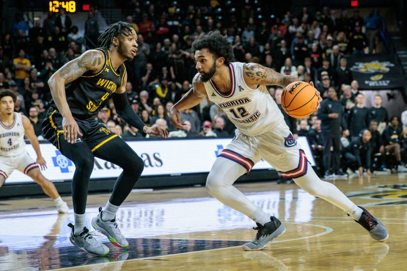 Feb 11, 2024; Wichita, Kansas, USA; Florida Atlantic Owls guard Jalen Gaffney (12) drives around Wichita State Shockers guard Colby Rogers (4) during the second half at Charles Koch Arena. Mandatory Credit: William Purnell-USA TODAY Sports