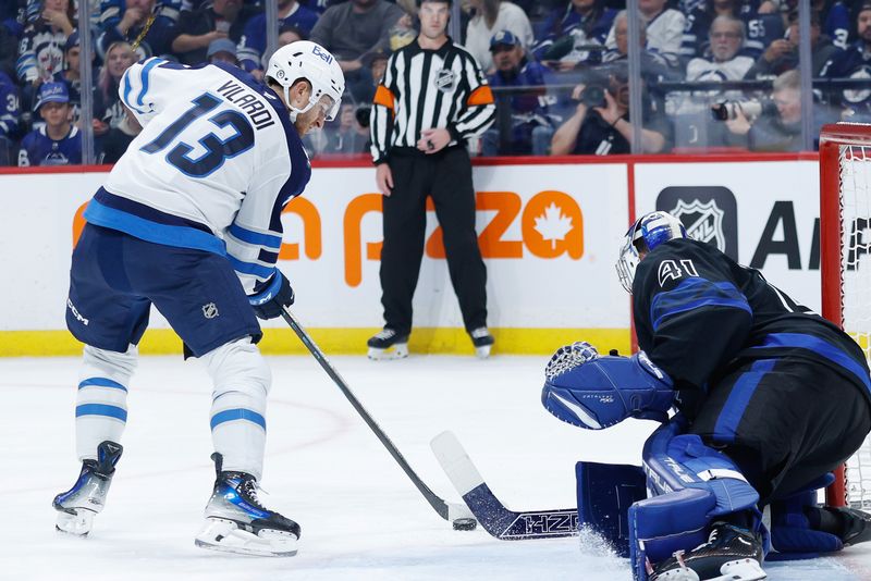 Oct 28, 2024; Winnipeg, Manitoba, CAN; Winnipeg Jets forward Gabriel Vilardi (13) with the puck in front of Toronto Maple Leafs goalie Anthony Stolarz (41) during the second period at Canada Life Centre. Mandatory Credit: Terrence Lee-Imagn Images