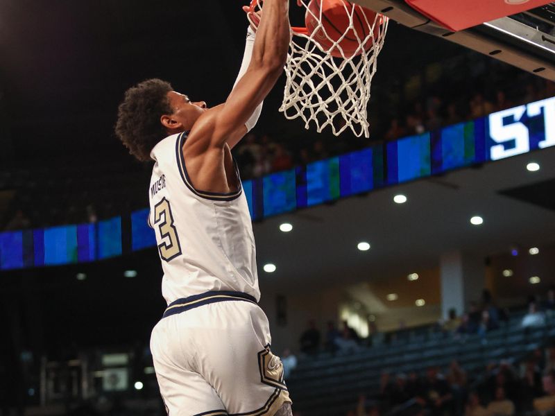 Jan 14, 2025; Atlanta, Georgia, USA; Georgia Tech guard Jaeden Mustaf dunks against the Clemson Tigers during the first half at McCamish Pavilion. Mandatory Credit: Jordan Godfree-Imagn Images