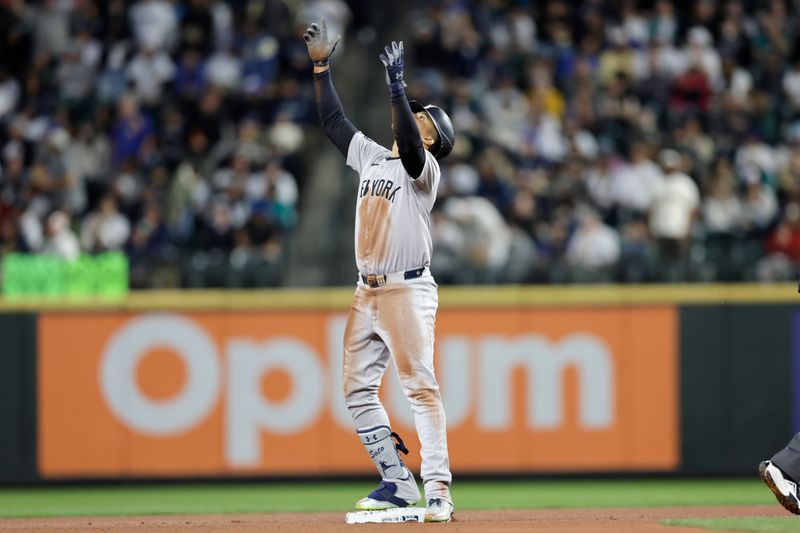 Sep 18, 2024; Seattle, Washington, USA; New York Yankees right fielder Juan Soto (22) points from second on his double against the Seattle Mariners during the third inning  at T-Mobile Park. Mandatory Credit: John Froschauer-Imagn Images