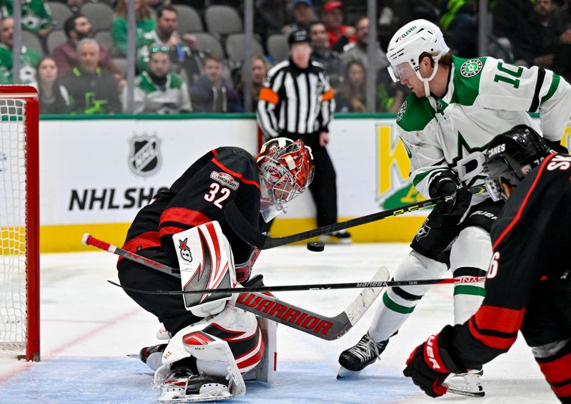 Jan 25, 2023; Dallas, Texas, USA; Carolina Hurricanes goaltender Antti Raanta (32) stops a shot by Dallas Stars center Ty Dellandrea (10) during the second period at the American Airlines Center. Mandatory Credit: Jerome Miron-USA TODAY Sports