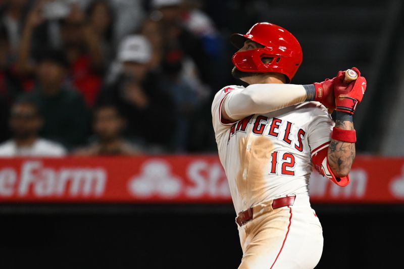 May 11, 2024; Anaheim, California, USA; Los Angeles Angels outfielder Kevin Pillar (12) hits a two run single against the Kansas City Royals during the seventh inning at Angel Stadium. Mandatory Credit: Jonathan Hui-USA TODAY Sports