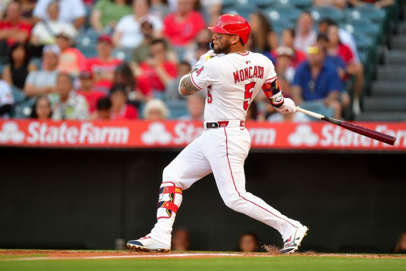 May 10, 2025; Anaheim, California, USA; Los Angeles Angels third baseman Yoán Moncada (5) hits an RBI single against the Baltimore Orioles during the first inning at Angel Stadium. Mandatory Credit: Gary A. Vasquez-Imagn Images