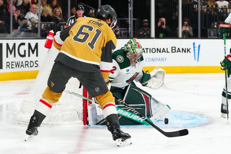 Feb 12, 2024; Las Vegas, Nevada, USA; Minnesota Wild goaltender Filip Gustavsson (32) makes a save as Vegas Golden Knights right wing Mark Stone (61) looks for the rebound during the third period at T-Mobile Arena. Mandatory Credit: Stephen R. Sylvanie-USA TODAY Sports