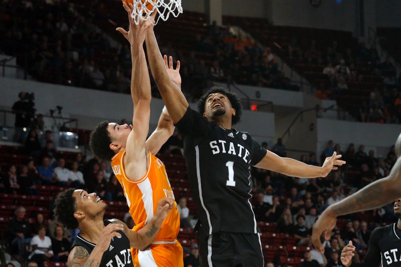 Jan 17, 2023; Starkville, Mississippi, USA; Tennessee Volunteers forward Olivier Nkamhoua (13) and Mississippi State Bulldogs forward Tolu Smith (1) battle for a rebound during the first half at Humphrey Coliseum. Mandatory Credit: Petre Thomas-USA TODAY Sports