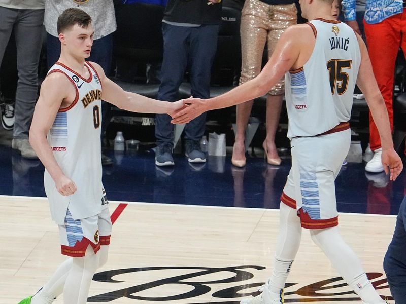 DENVER, CO - JUNE 12: Christian Braun #0 of the Denver Nuggets & Nikola Jokic #15 of the Denver Nuggets high five during the game  during Game Five of the 2023 NBA Finals on June 12, 2023 at the Ball Arena in Denver, Colorado. NOTE TO USER: User expressly acknowledges and agrees that, by downloading and/or using this Photograph, user is consenting to the terms and conditions of the Getty Images License Agreement. Mandatory Copyright Notice: Copyright 2023 NBAE (Photo by Bart Young/NBAE via Getty Images)