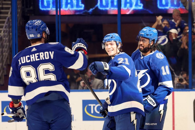 Apr 9, 2024; Tampa, Florida, USA; Tampa Bay Lightning center Brayden Point (21) is congratulated by right wing Nikita Kucherov (86) and left wing Anthony Duclair (10) after he scored against the Columbus Blue Jackets during the first period at Amalie Arena. Mandatory Credit: Kim Klement Neitzel-USA TODAY Sports