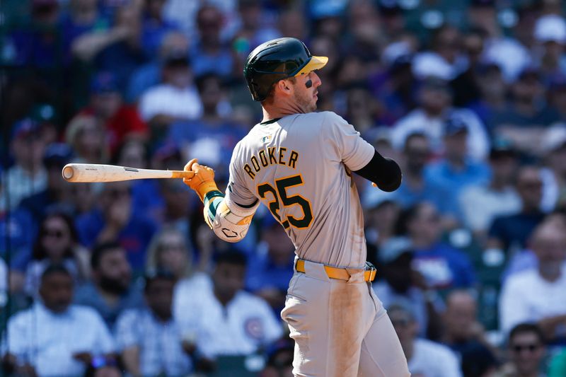 Sep 18, 2024; Chicago, Illinois, USA; Oakland Athletics outfielder Brent Rooker (25) hits an RBI-single against the Chicago Cubs during the seventh inning at Wrigley Field. Mandatory Credit: Kamil Krzaczynski-Imagn Images