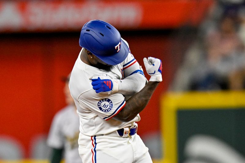 Apr 10, 2024; Arlington, Texas, USA; Texas Rangers right fielder Adolis Garcia (53) celebrates at second base after he hits a double against the Oakland Athletics during the third inning at Globe Life Field. Mandatory Credit: Jerome Miron-USA TODAY Sports