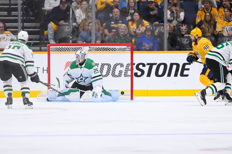 Oct 10, 2024; Nashville, Tennessee, USA; Nashville Predators center Jonathan Marchessault (81) scores against Dallas Stars goaltender Jake Oettinger (29) during the second period at Bridgestone Arena. Mandatory Credit: Steve Roberts-Imagn Images