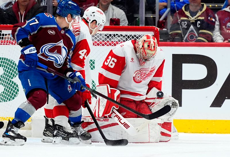 Feb 2, 2026; Denver, Colorado, USA; Detroit Red Wings goaltender John Gibson (36) makes a save next to defenseman Axel Sandin-Pellikka (44) and Colorado Avalanche center Parker Kelly (17) in the first period at Ball Arena. Mandatory Credit: Ron Chenoy-Imagn Images