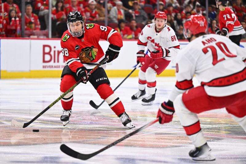 Apr 14, 2024; Chicago, Illinois, USA; Chicago Blackhawks forward Connor Bedard (98) controls the puck in the third period at United Center. Mandatory Credit: Jamie Sabau-USA TODAY Sports