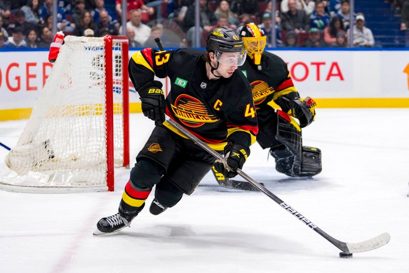 Mar 25, 2024; Vancouver, British Columbia, CAN;  Vancouver Canucks defenseman Quinn Hughes (43) handles the puck against the Los Angeles Kings in the second period at Rogers Arena. Mandatory Credit: Bob Frid-USA TODAY Sports