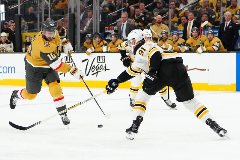 Mar 20, 2025; Las Vegas, Nevada, USA; Vegas Golden Knights center Nicolas Roy (10) shoots against Boston Bruins defenseman Nikita Zadorov (91) during the second period at T-Mobile Arena. Mandatory Credit: Stephen R. Sylvanie-Imagn Images