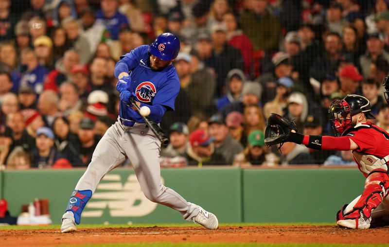 Apr 26, 2024; Boston, Massachusetts, USA; Chicago Cubs first baseman Michael Busch (29) hits a sacrifice fly to drive in a run against the Boston Red Sox in the fifth inning at Fenway Park. Mandatory Credit: David Butler II-USA TODAY Sports