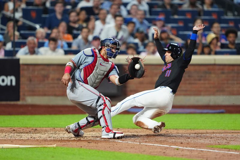 Jul 10, 2024; New York City, New York, USA; New York Mets second baseman Jose Iglesias (11) scores a run with Washington Nationals catcher Keibert Ruiz (20) catching a throw during the sixth inning at Citi Field. Mandatory Credit: Gregory Fisher-USA TODAY Sports