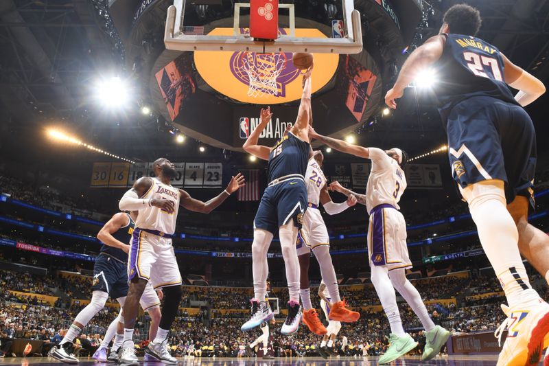 LOS ANGELES, CA - APRIL 27: Nikola Jokic #15 of the Denver Nuggets drives to the basket during the game against the Los Angeles Lakers during Round 1 Game 4 of the 2024 NBA Playoffs on April 27, 2024 at Crypto.Com Arena in Los Angeles, California. NOTE TO USER: User expressly acknowledges and agrees that, by downloading and/or using this Photograph, user is consenting to the terms and conditions of the Getty Images License Agreement. Mandatory Copyright Notice: Copyright 2024 NBAE (Photo by Andrew D. Bernstein/NBAE via Getty Images)