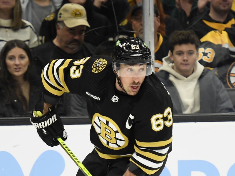 Feb 13, 2024; Boston, Massachusetts, USA;  Boston Bruins left wing Brad Marchand (63) skates with the puck during the first period against the Tampa Bay Lightning at TD Garden. Mandatory Credit: Bob DeChiara-USA TODAY Sports