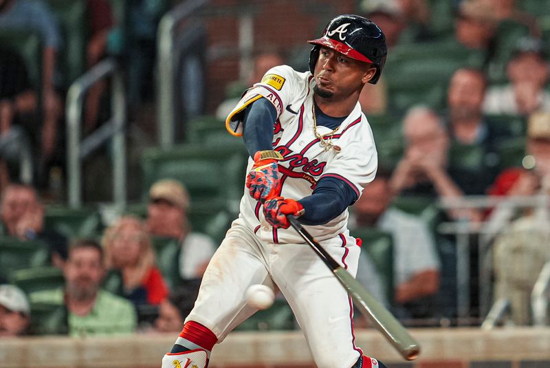 May 13, 2025; Cumberland, Georgia, USA; Atlanta Braves second baseman Ozzie Albies (1) hits a single to drive in a run against the Washington Nationals during the eighth inning at Truist Park. Mandatory Credit: Dale Zanine-Imagn Images