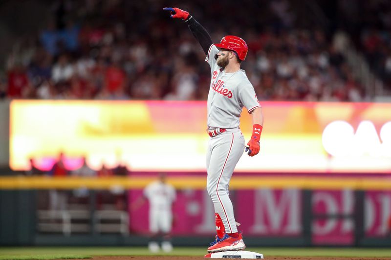 Oct 12, 2022; Atlanta, Georgia, USA; Philadelphia Phillies designated hitter Bryce Harper (3) reacts after hitting a double against the Atlanta Braves in the second inning during game two of the NLDS for the 2022 MLB Playoffs at Truist Park. Mandatory Credit: Brett Davis-USA TODAY Sports