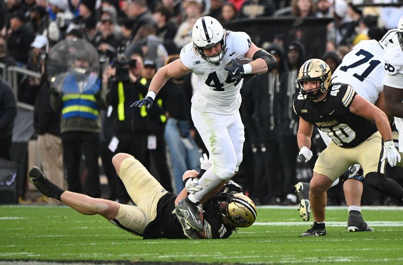 Nov 16, 2024; West Lafayette, Indiana, USA;  Penn State Nittany Lions tight end Tyler Warren (44) is tackled by Purdue Boilermakers defensive end Will Heldt (15) during the second quarter at Ross-Ade Stadium. Mandatory Credit: Marc Lebryk-Imagn Images