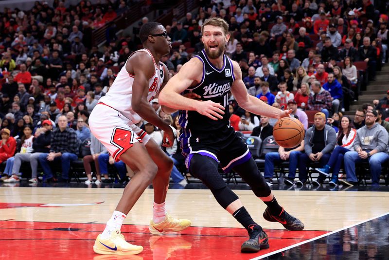 CHICAGO, ILLINOIS - JANUARY 12: Domantas Sabonis #11 of the Sacramento Kings drives to the basket against Jalen Smith #7 of the Chicago Bulls during the first half at the United Center on January 12, 2025 in Chicago, Illinois. NOTE TO USER: User expressly acknowledges and agrees that, by downloading and or using this photograph, User is consenting to the terms and conditions of the Getty Images License Agreement. (Photo by Justin Casterline/Getty Images)