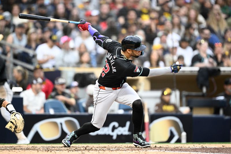 Jun 8, 2024; San Diego, California, USA;  Arizona Diamondbacks left fielder Lourdes Gurriel Jr. (12) hits a single during the fifth inning against the San Diego Padres at Petco Park. Mandatory Credit: Denis Poroy-USA TODAY Sports at Petco Park. 