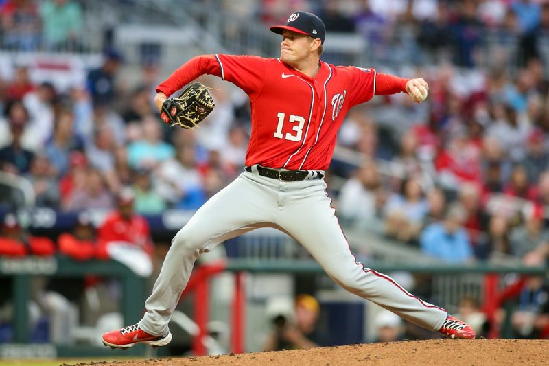 Apr 11, 2022; Atlanta, Georgia, USA; Washington Nationals starting pitcher Josh Rogers (13) throws a pitch against the Atlanta Braves in the first inning at Truist Park. Mandatory Credit: Brett Davis-USA TODAY Sports