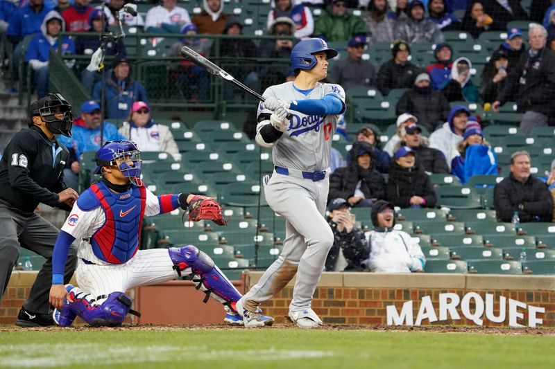 Apr 7, 2024; Chicago, Illinois, USA; Los Angeles Dodgers designated hitter Shohei Ohtani (17) hits a one run double against the Chicago Cubs during the eighth inning at Wrigley Field. Mandatory Credit: David Banks-USA TODAY Sports